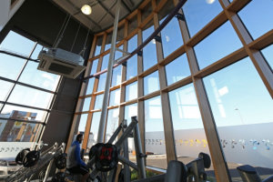 The internal spruce of Senior’s Hybrid timber composite Curtain Wall gives the gym a light and airy feel