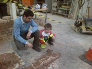 Senior’s Sales Director James Keeling-Heane and son William having a go at bricklaying