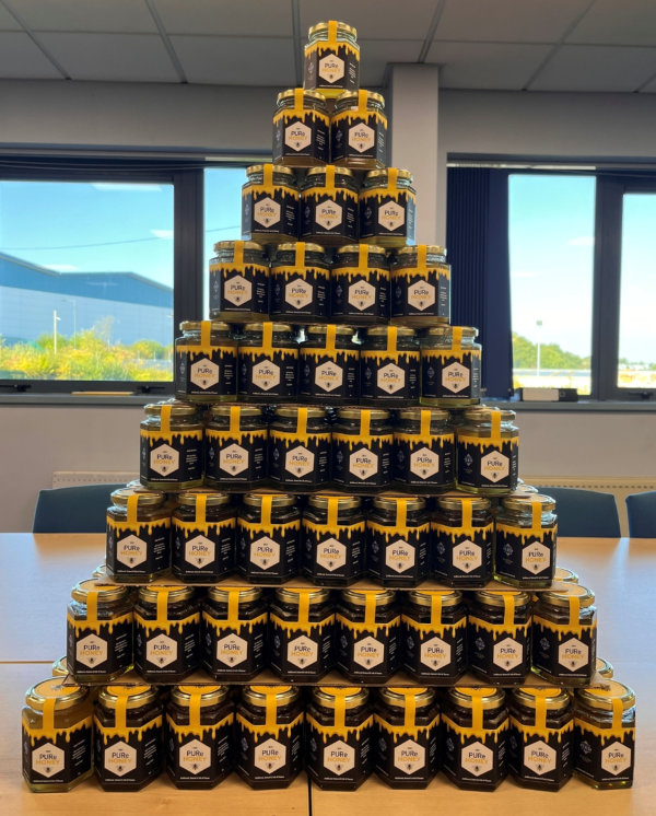 Photo of stacked jars of honey harvested from the SAS beehive